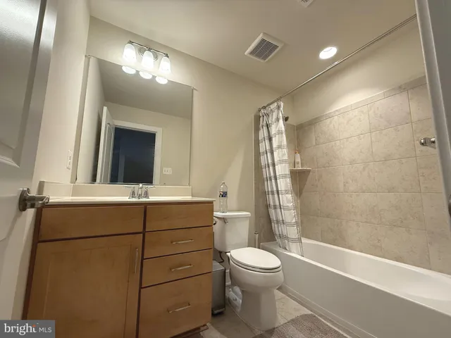 a bathroom with a toilet a sink and bathtub