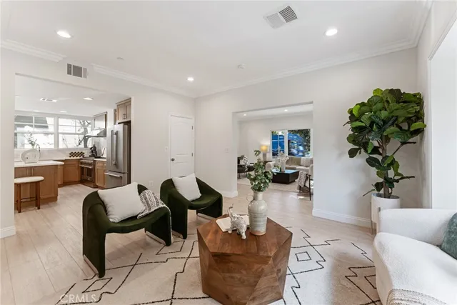 a dining room with furniture a chandelier and wooden floor