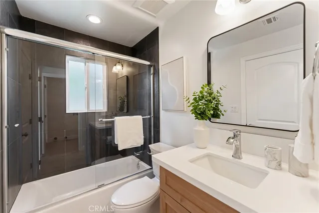 a view of an empty room with a window and closet area