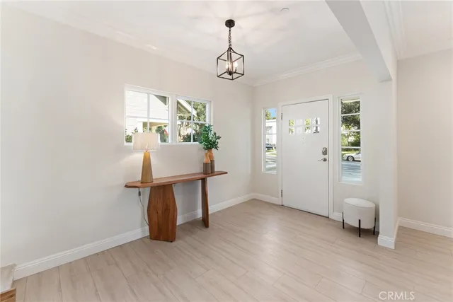 a living room with furniture a fireplace and a potted plant