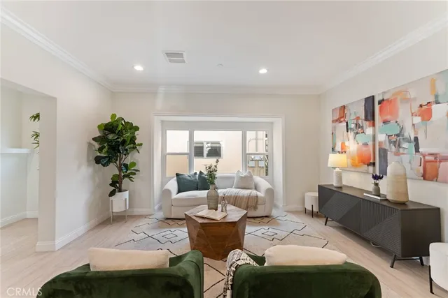 a kitchen with stainless steel appliances a refrigerator a stove a sink a dining table and chairs