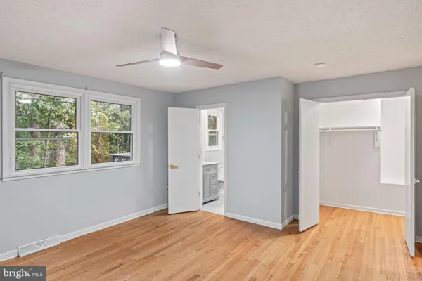 an empty room with wooden floor and closet