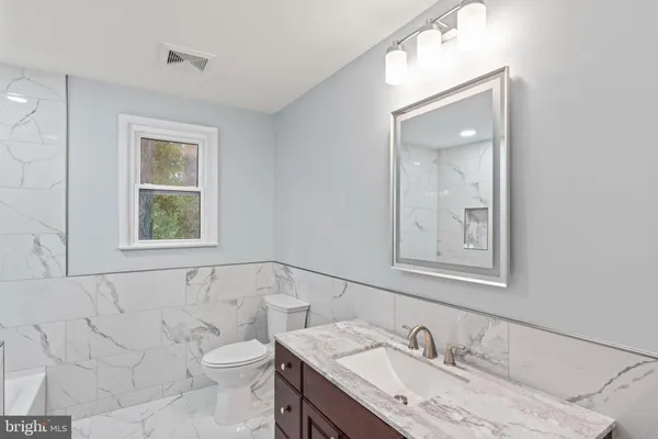 a bathroom with a bathtub and shower