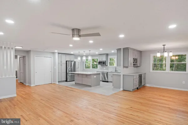 a kitchen with stainless steel appliances a refrigerator and microwave