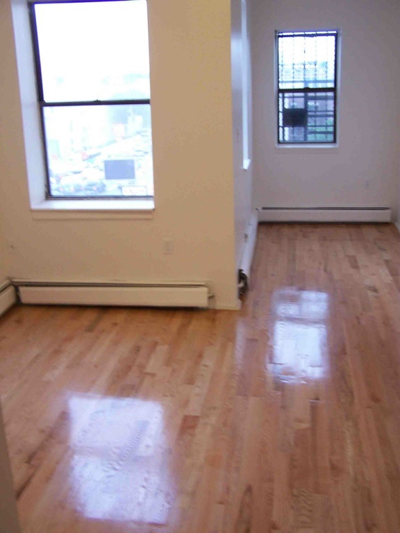 599 Grove Street, Unit 4 Jersey City, NJ 07310 - Photo 3 of 4 an empty room with a window