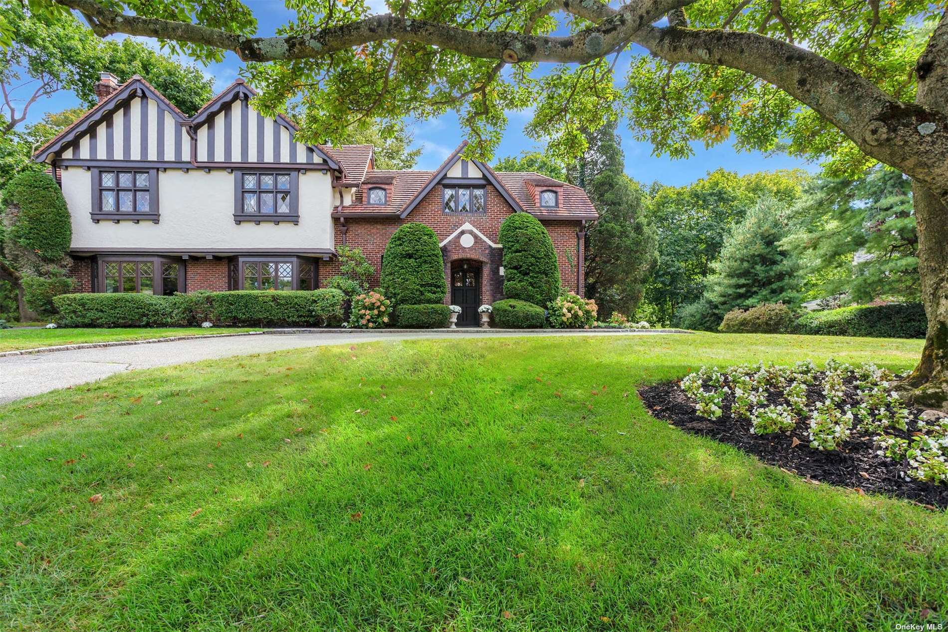 206 Bayview Road Manhasset, NY 11030 - Photo 1 of 1 a front view of a house with a garden