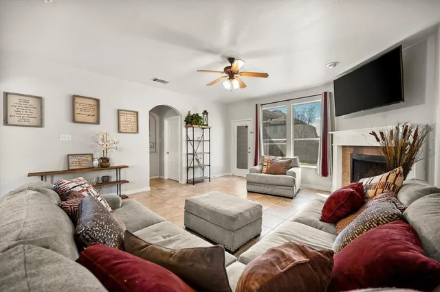 a living room with fireplace furniture and a flat screen tv