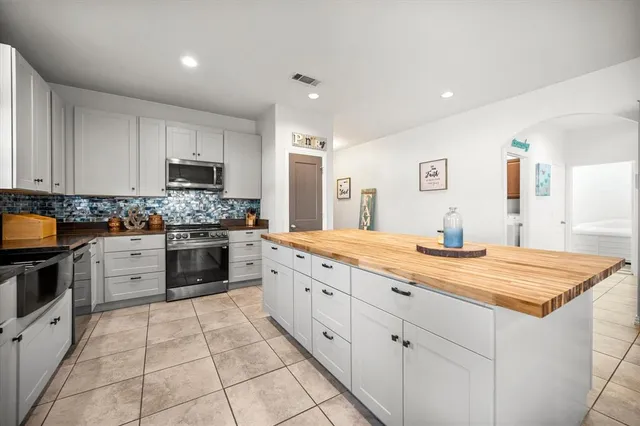 a spacious bathroom with a granite countertop sink a mirror and a vanity