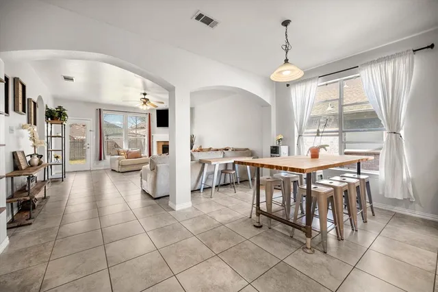 a dining hall with stainless steel appliances a table and chairs