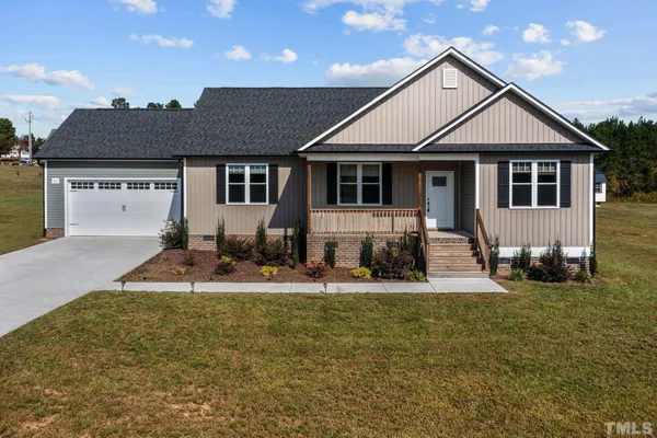 a front view of a house with large windows