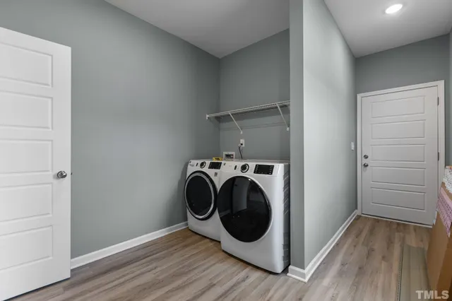 a utility room with washing machine and a view of bedroom