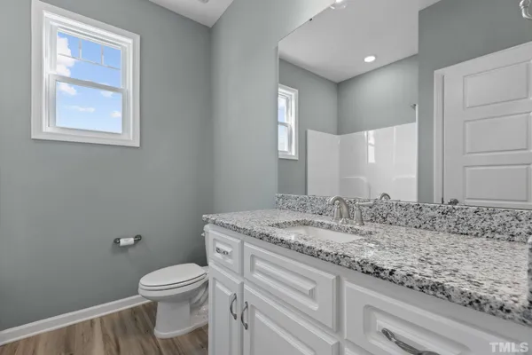 a bathroom with a tub shower vanity and a sink