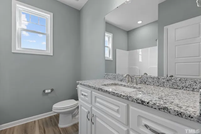 a bathroom with a tub shower vanity and a sink