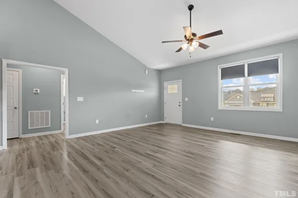 wooden floor in an empty room with a window