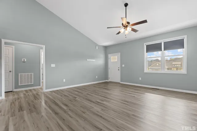 wooden floor in an empty room with a window