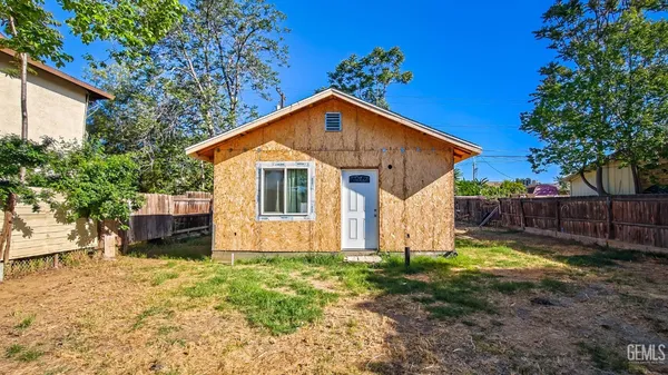 a view of a house with a yard and a garden
