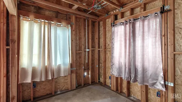 a view of empty room with wooden walls