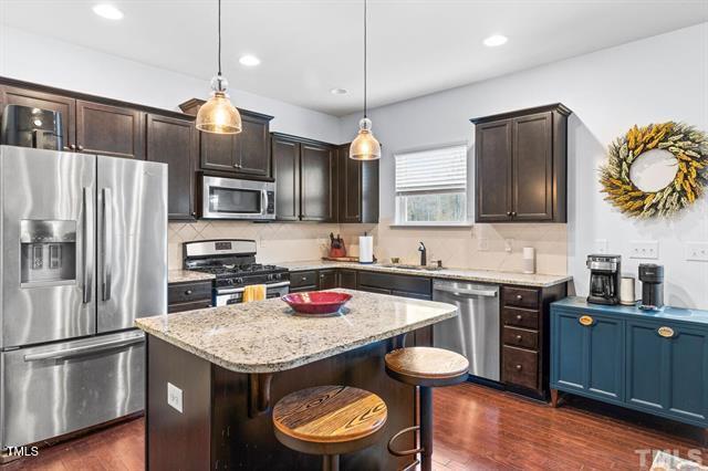 2652 Averon Drive Fuquay-Varina, NC 27526 - Photo 3 of 11 a kitchen with a center island and stainless steel appliances