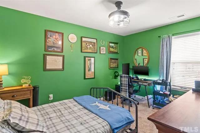 a bedroom with a bed and a table