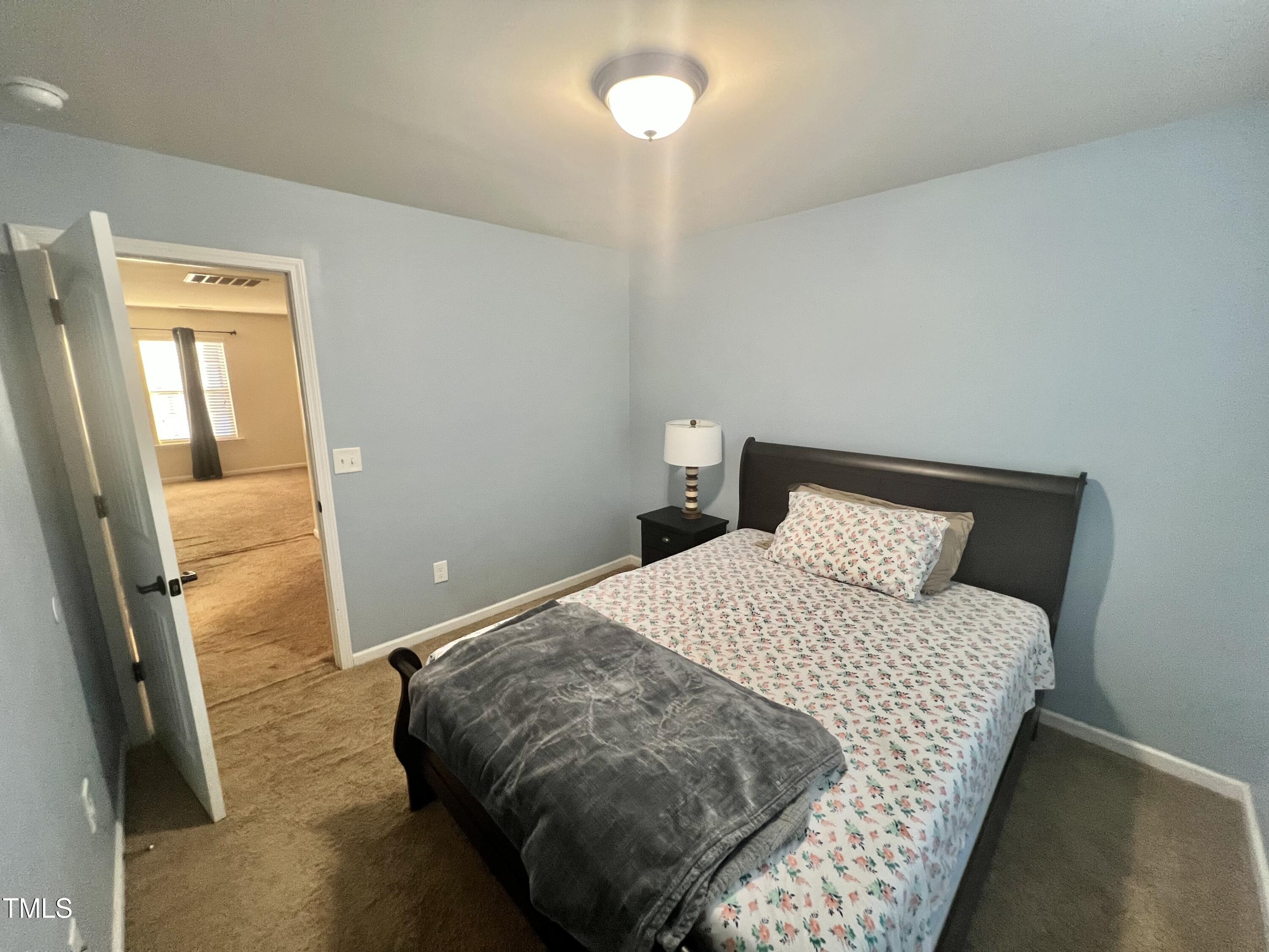 2652 Averon Drive Fuquay-Varina, NC 27526 - Photo 10 of 11 a bedroom with a bed and a window