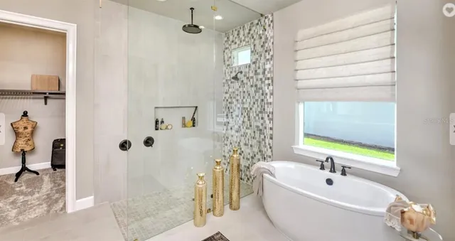 a bedroom with a bed mirror and a large window