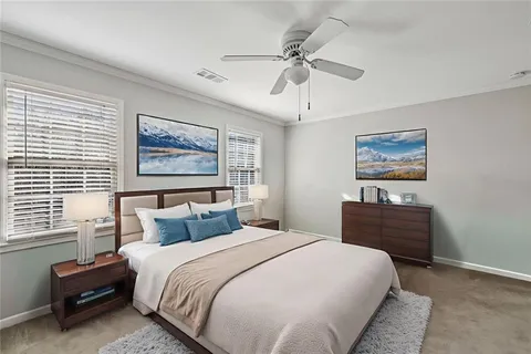 a bedroom with a bed and a painting on the wall