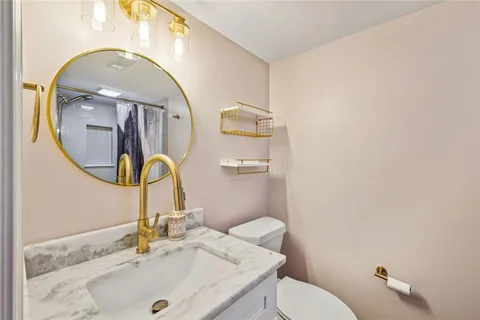 a bathroom with a sink and a mirror with toilet