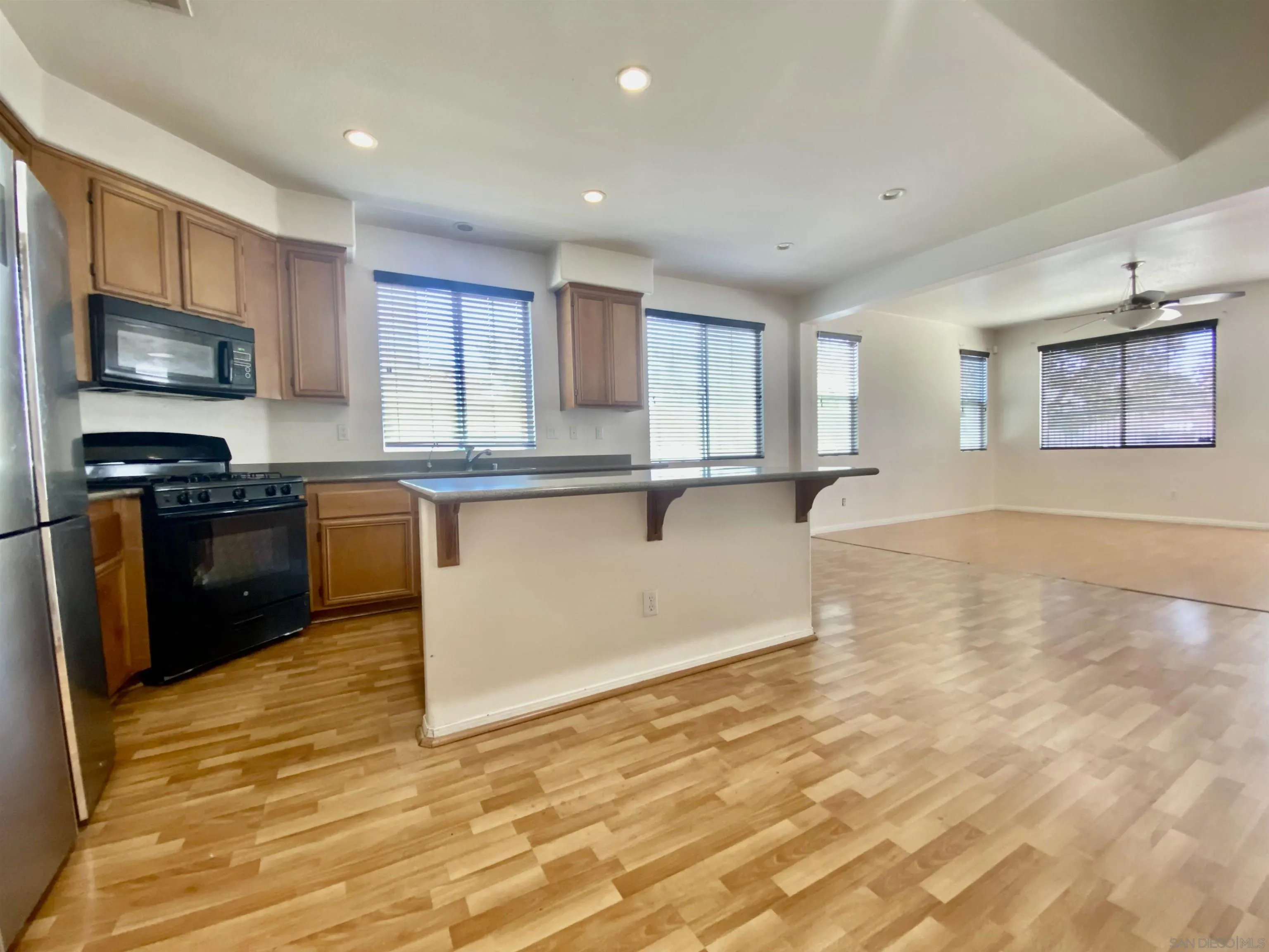 1301 Bee Balm Road Hemet, CA 92545 - Photo 3 of 17 a kitchen with stainless steel appliances granite countertop a stove a sink and a microwave