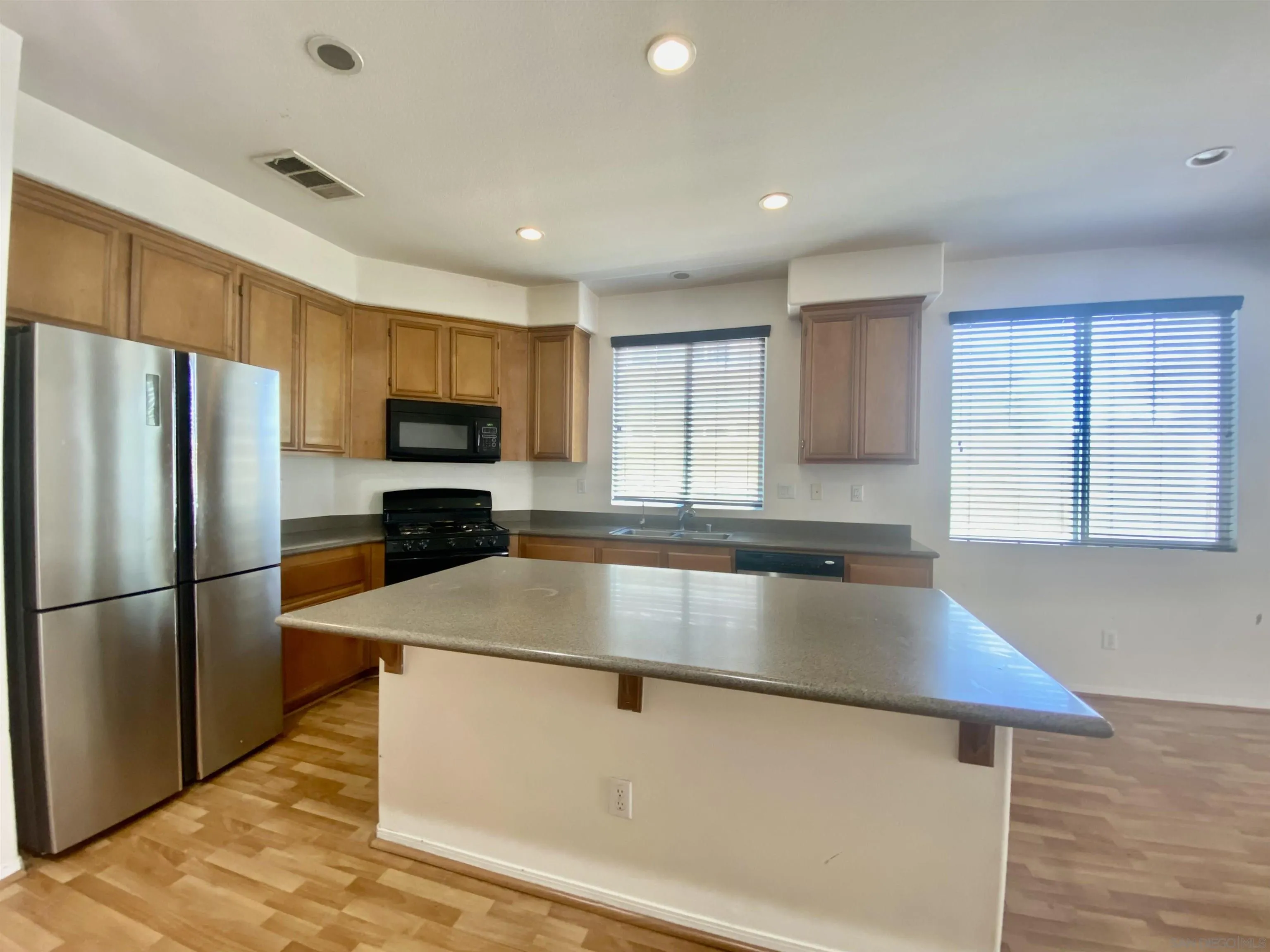 1301 Bee Balm Road Hemet, CA 92545 - Photo 5 of 17 a kitchen with stainless steel appliances granite countertop a refrigerator a sink a stove a microwave and island