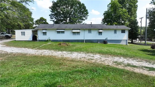 a view of a house with a yard and tree s