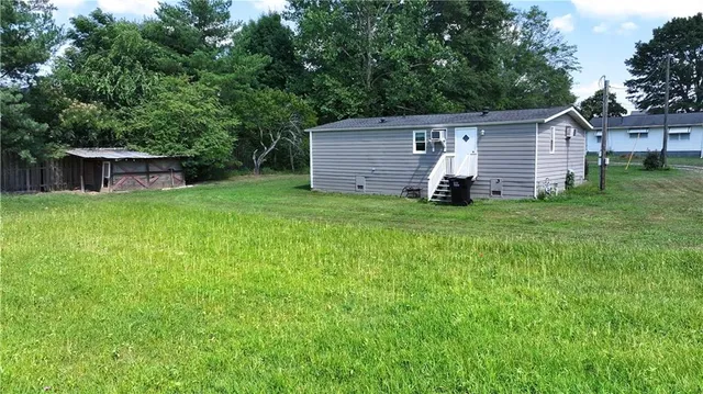 a backyard of a house with table and chairs