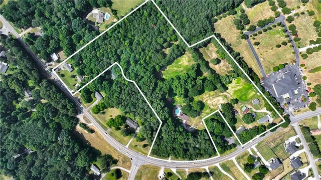 a view of a house with a yard and sitting area