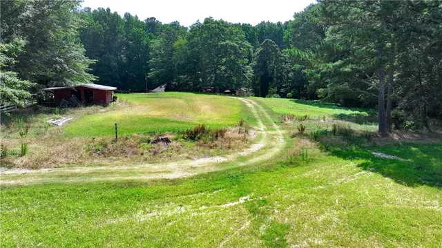 a backyard of a house with lots of plants and trees