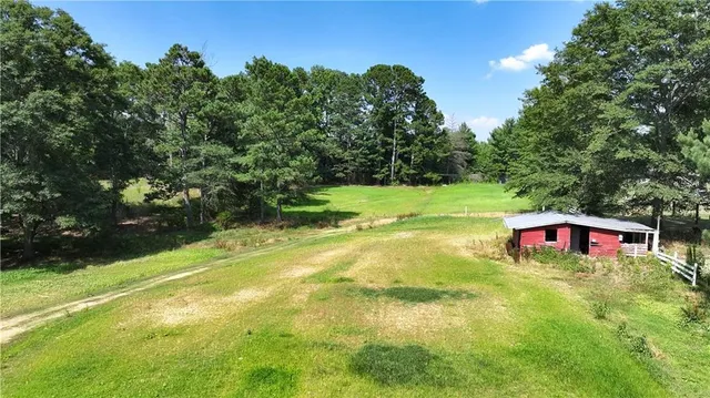 an aerial view of a house with a yard and garden