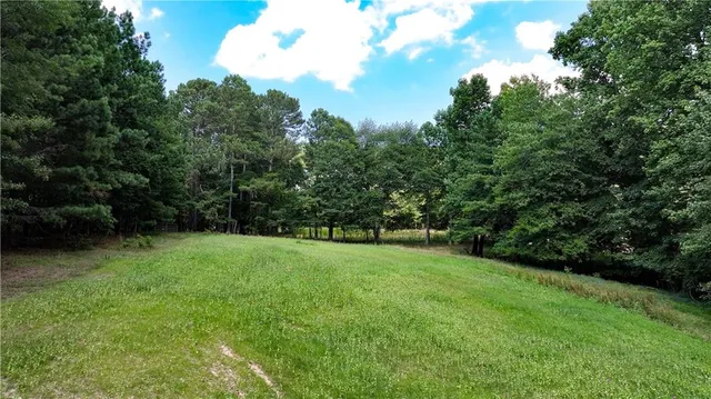 an aerial view of residential house with outdoor space and swimming pool