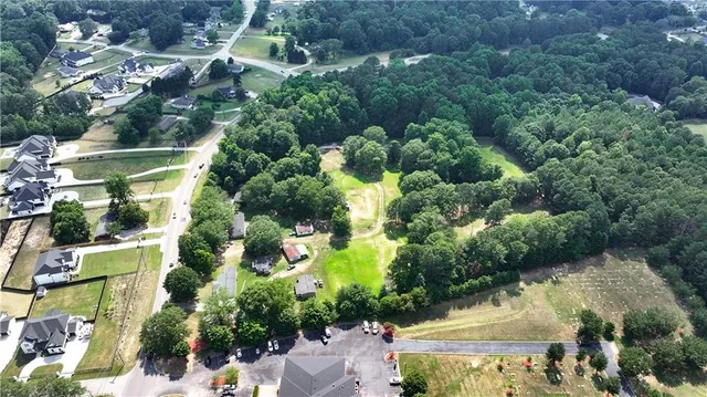 a view of pool with table and chairs under an umbrella