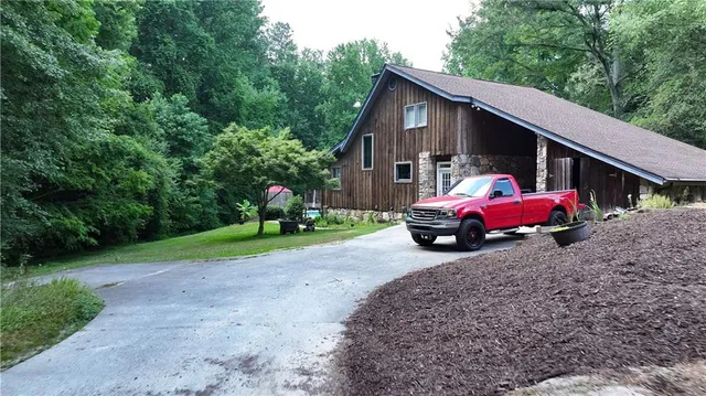 a view of a house with wooden fence and a yard