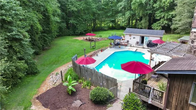an aerial view of a house with a yard basket ball court and outdoor seating