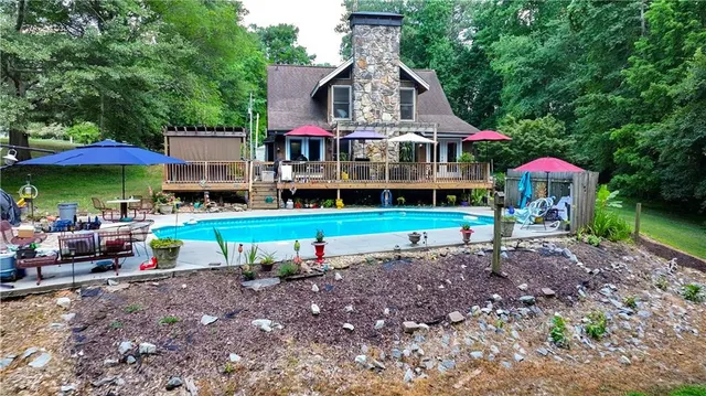 a view of a house with a yard potted plants and large tree