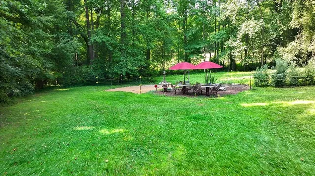 an aerial view of residential houses with outdoor space and trees