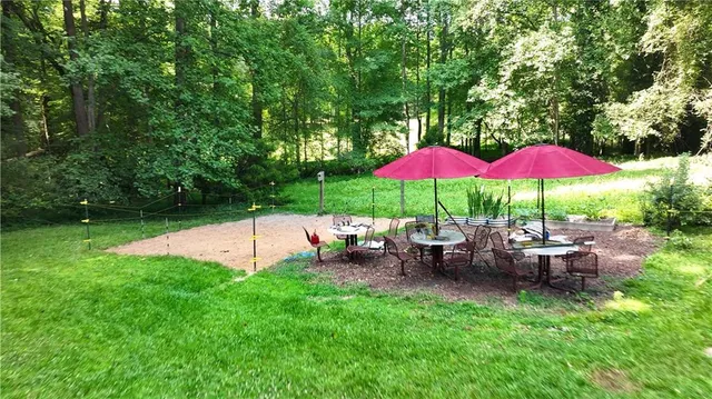 an aerial view of residential houses with outdoor space and trees