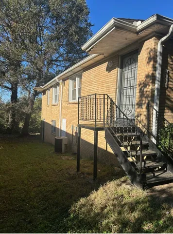 a view of backyard with deck and seating area
