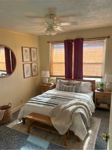 a bedroom with a bed and window