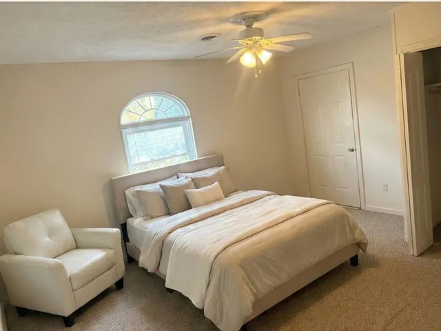 a bedroom with a bed and a couch