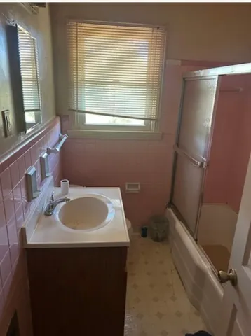 a bathroom with a sink toilet and a mirror