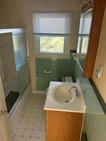 a bathroom with a sink a mirror and a shower