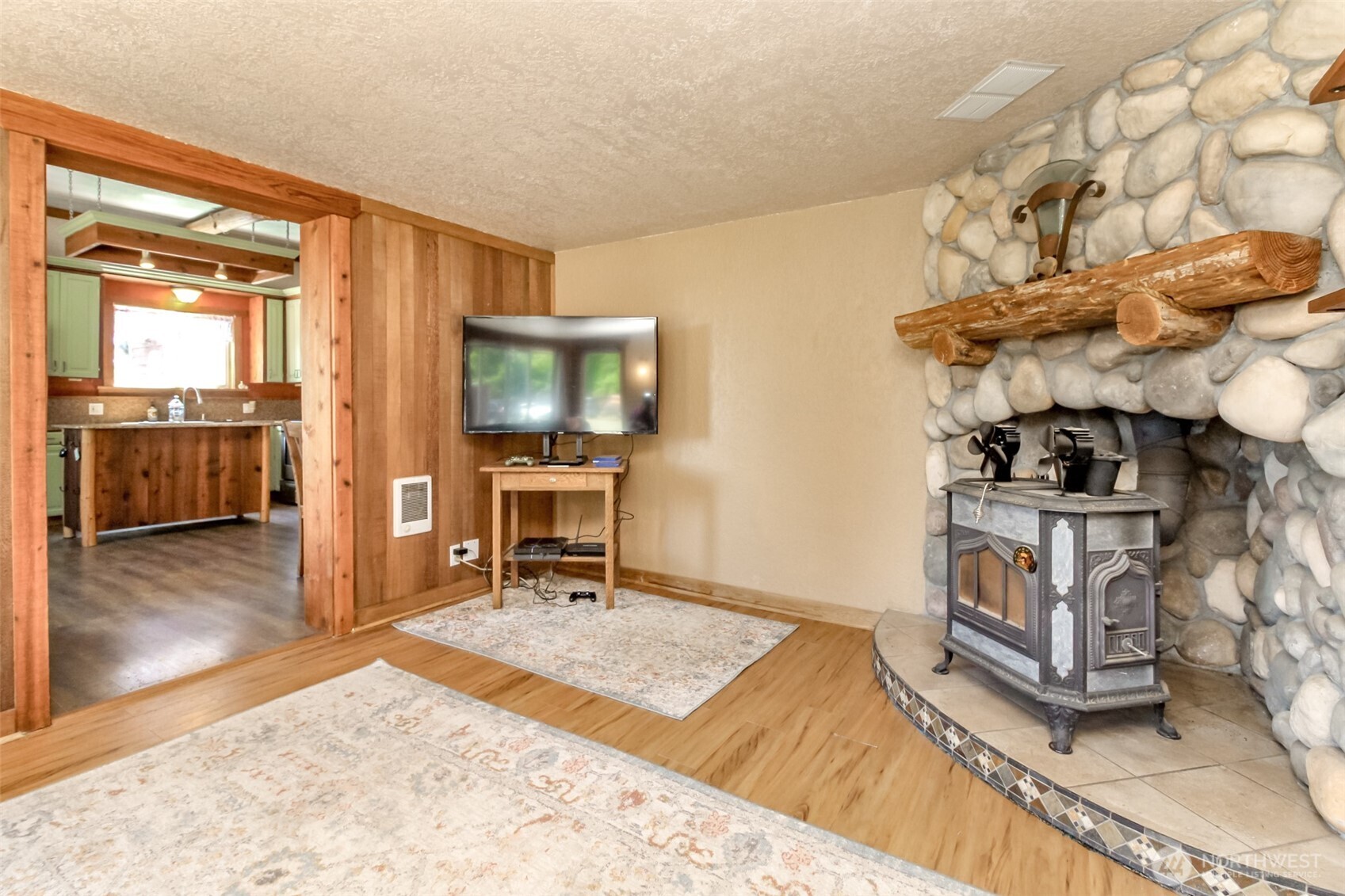 3116 Harts Lake Road South Roy, WA 98580 - Photo 13 of 39 a living room with furniture a flat screen tv and a stove