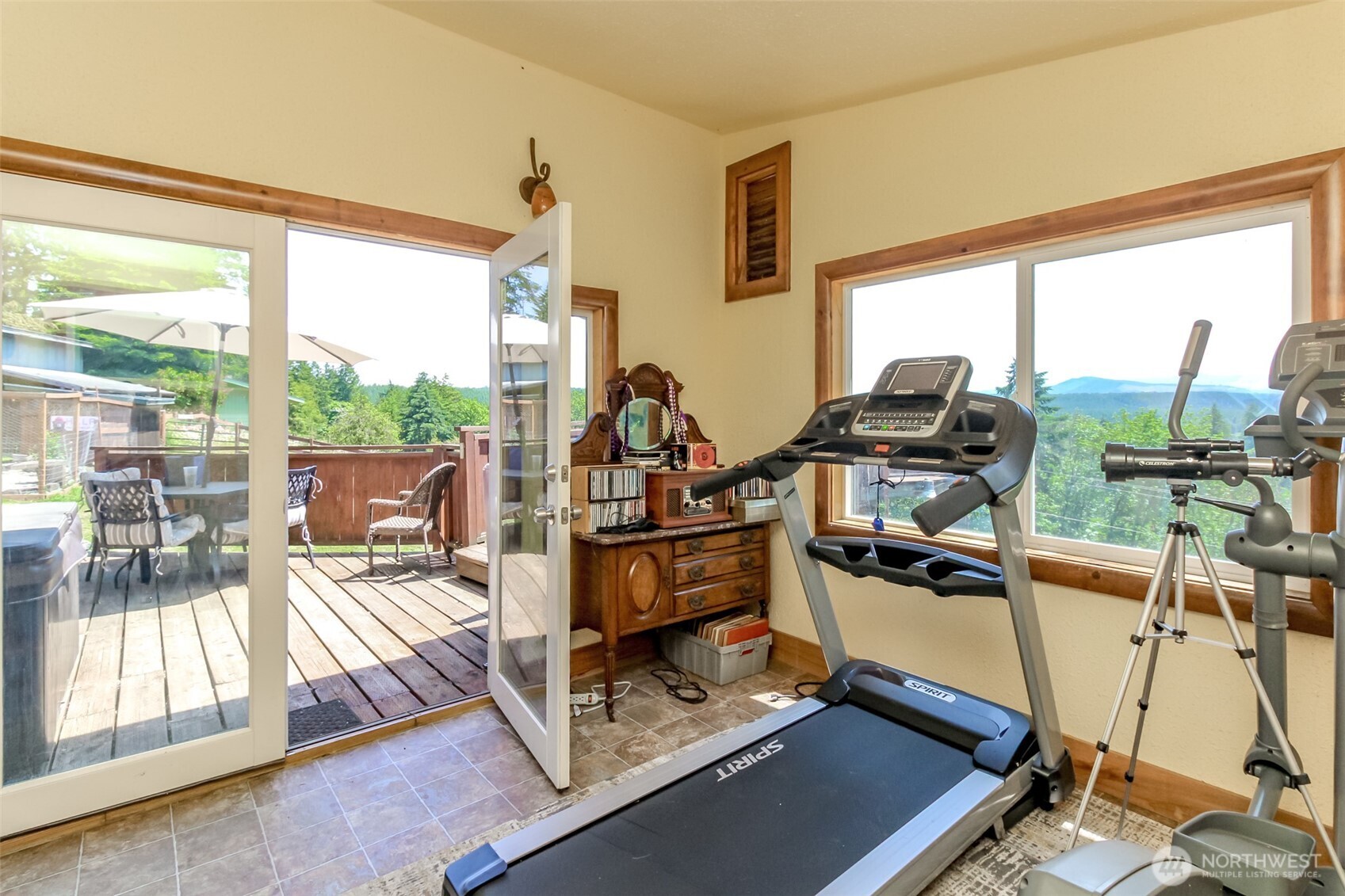 3116 Harts Lake Road South Roy, WA 98580 - Photo 29 of 39 a living room with furniture a flat screen tv and a floor to ceiling window