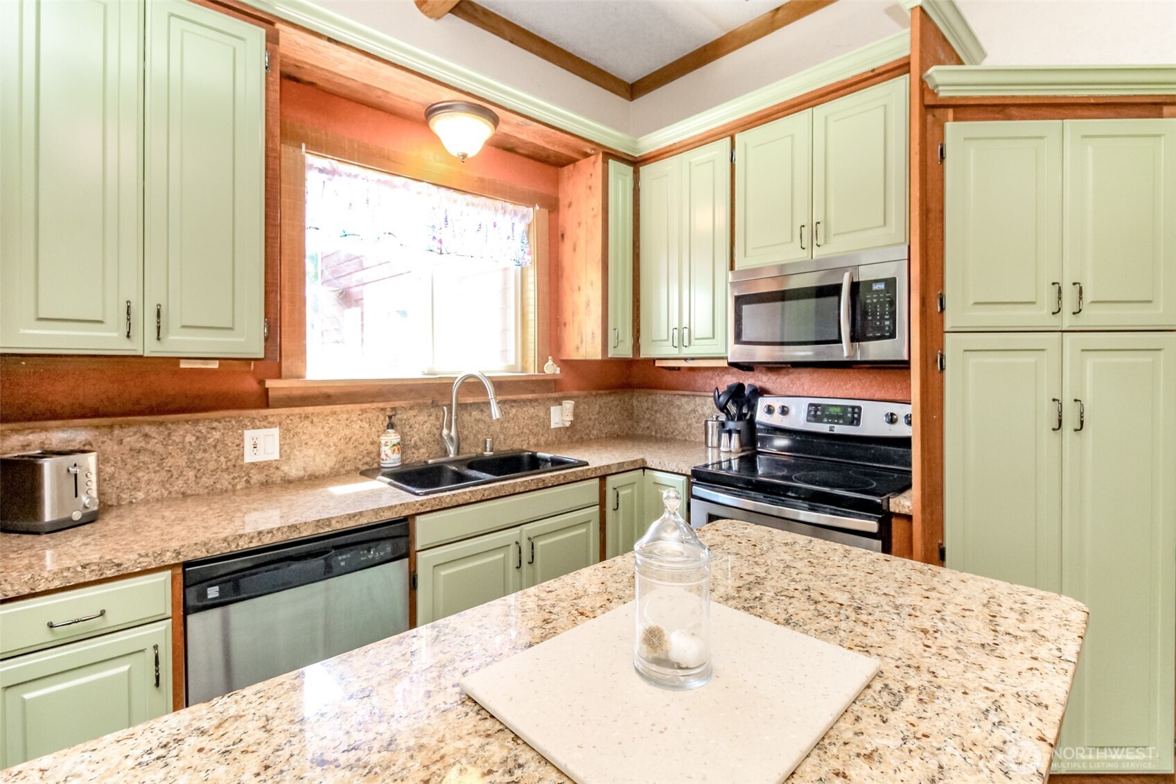 3116 Harts Lake Road South Roy, WA 98580 - Photo 9 of 39 a kitchen with stainless steel appliances kitchen island granite countertop a sink stove and refrigerator