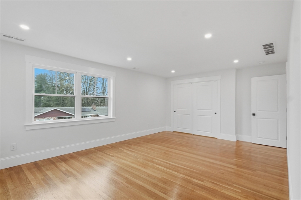 105 Stafford Road Lowell, MA 01852 - Photo 15 of 42 a view of an empty room with wooden floor and a window